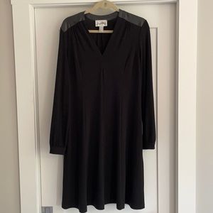 Black swing dress with leather shoulder trim